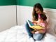 mom reading a children`s book to baby