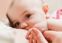 woman breastfeeding her newborn baby