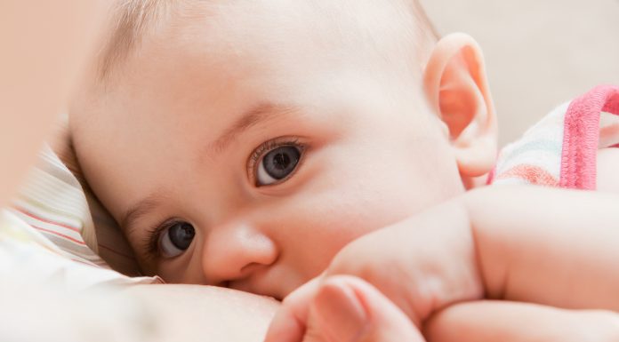 woman breastfeeding her newborn baby