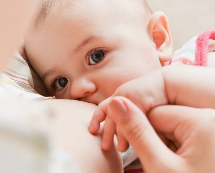 woman breastfeeding her newborn baby