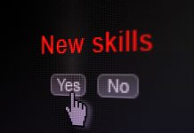 Black computer screen showing YES and NO options to New Skills; cursor pointing to YES