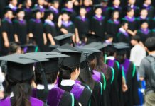 Back of graduates during commencement at university