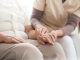 Close-up of nurse taking care about elderly person