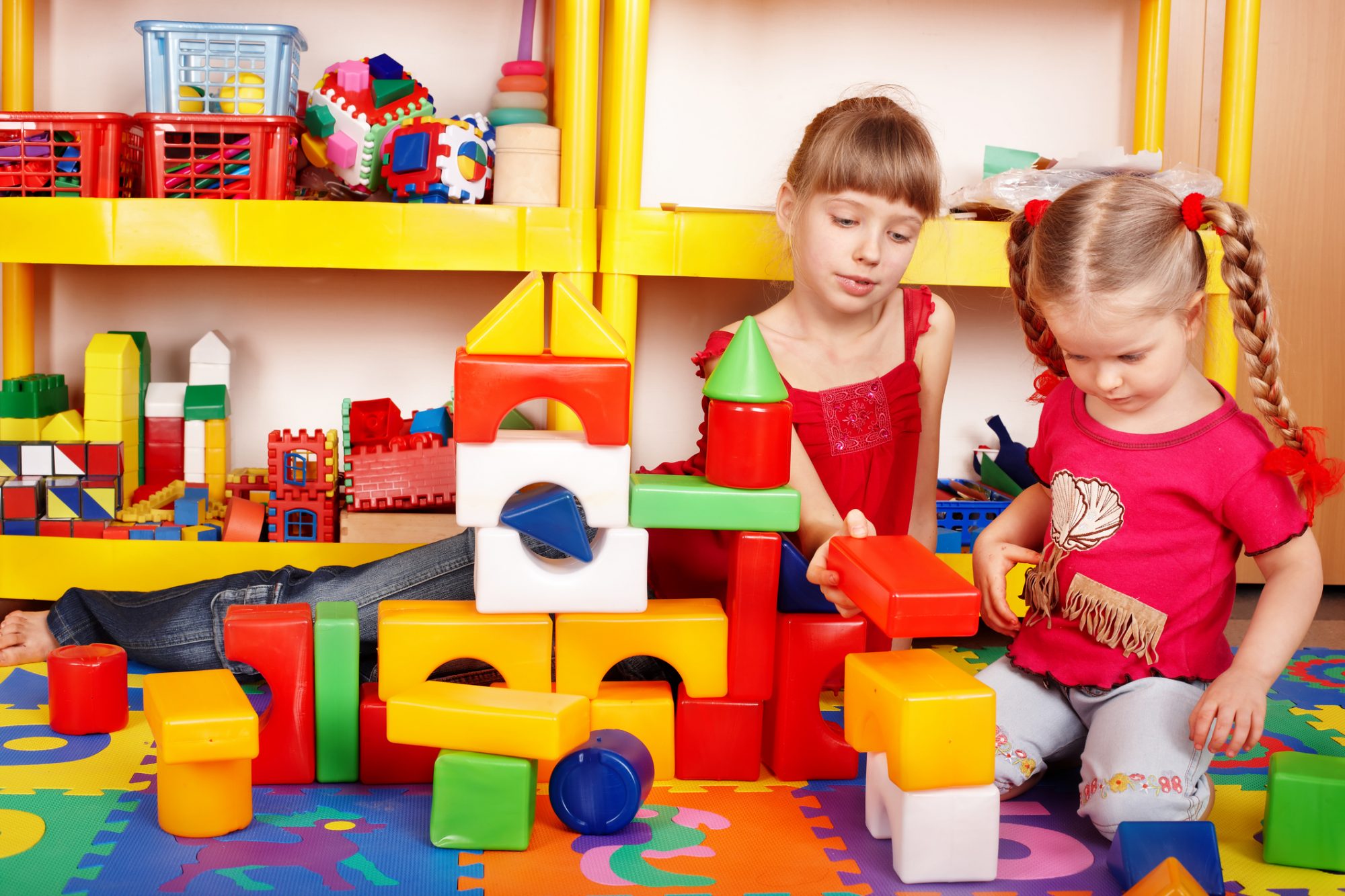 Child with block in play room