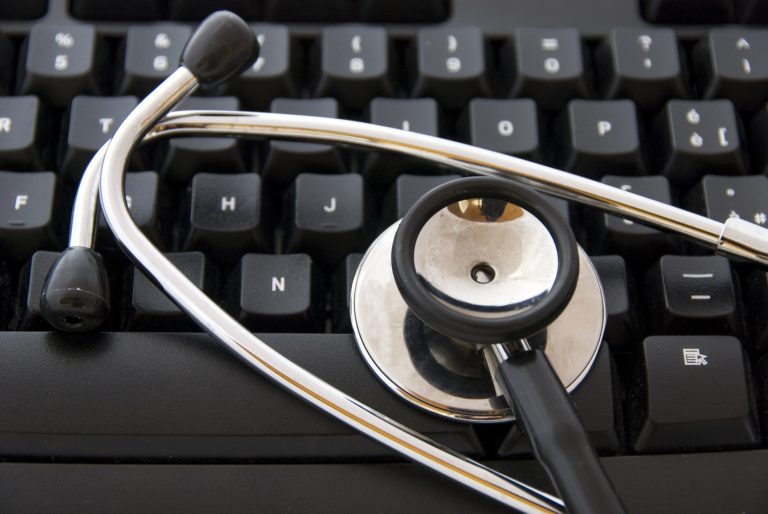 Stethoscope by a computer keyboard