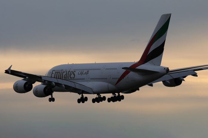 Emirates A380 plane flight in the sky, dusk