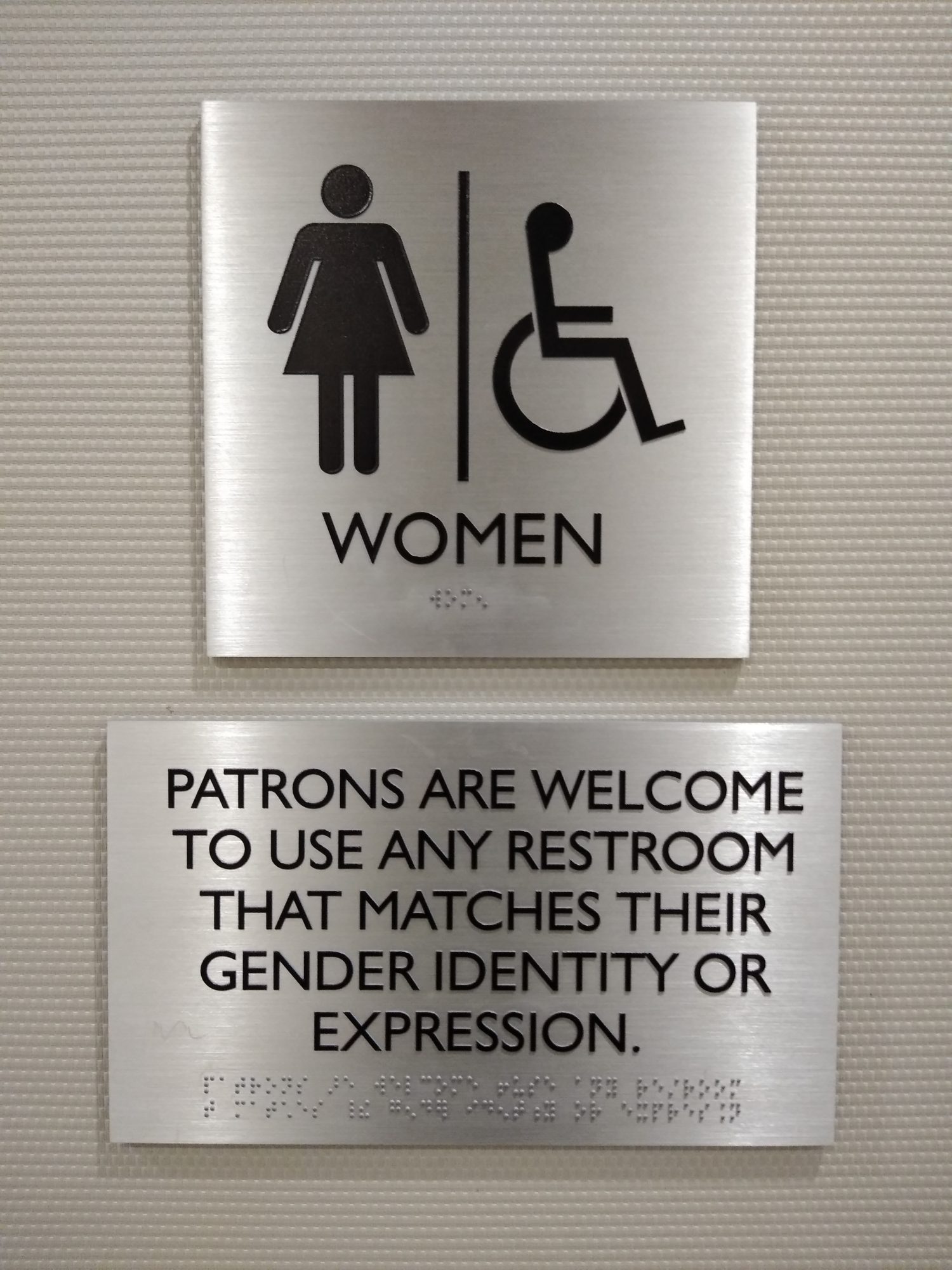 Although this bathroom sign is labeled for WOMEN, this establishment clarifies that patrons are welcome to use any restroom matching their gender identity or expression. This photo was taken in New York City on August 28th 2019.