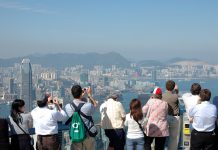 Tourists sightseeing the Hong Kong skyline at the Peak