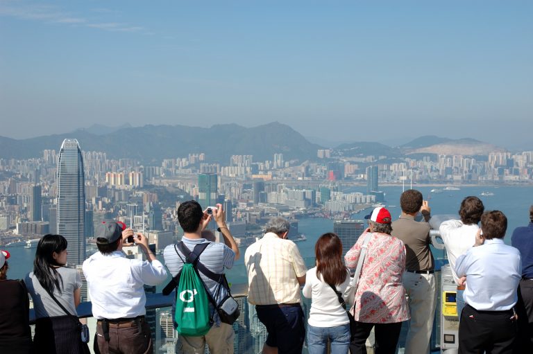 Tourists sightseeing the Hong Kong skyline at the Peak