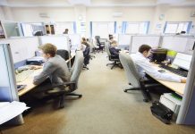 Officer workers sat down at their desks doing work