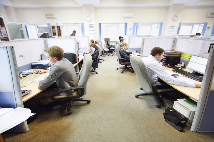 Officer workers sat down at their desks doing work