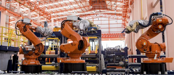 Robots welding in a production line