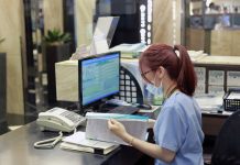 woman working on an EHR in a hospital