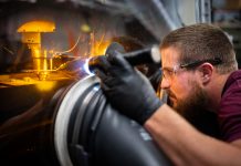 Levi Van Bastian works to print material on the LENS machine on Dec. 21, 2022, allowing the ability to test 3D print new superalloys.