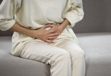 Lady suffering from strong stomach ache, gastritis, problems with bladder