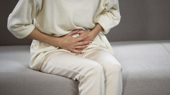 Lady suffering from strong stomach ache, gastritis, problems with bladder