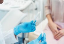 Gynecologist testing vaginal swab for STD