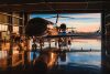 Servicing business aviation at a hangar in backlight at sunset
