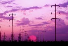 Energy towers on a bright dawn sky background (silhouette).