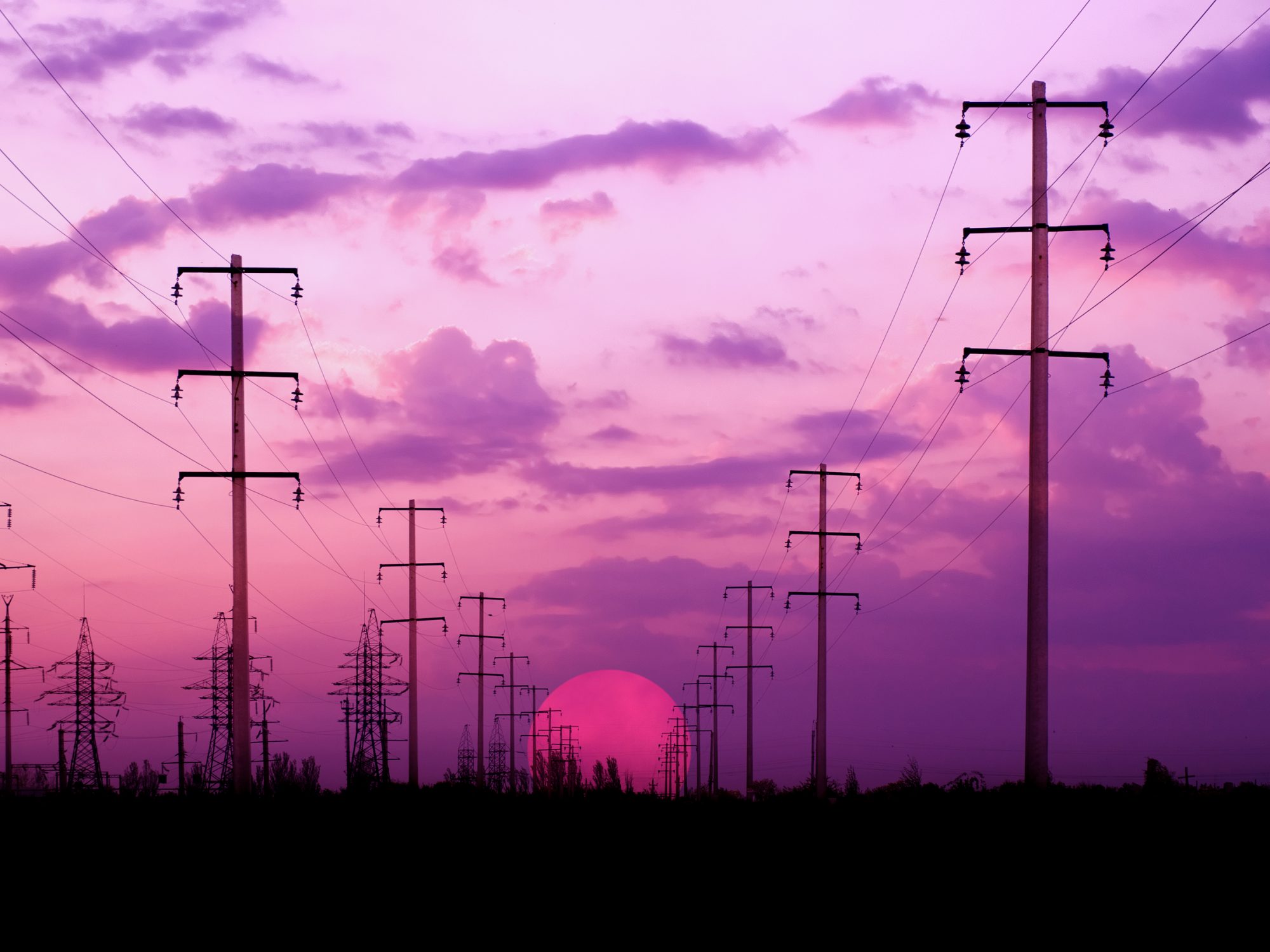 Energy towers on a bright dawn sky background (silhouette).