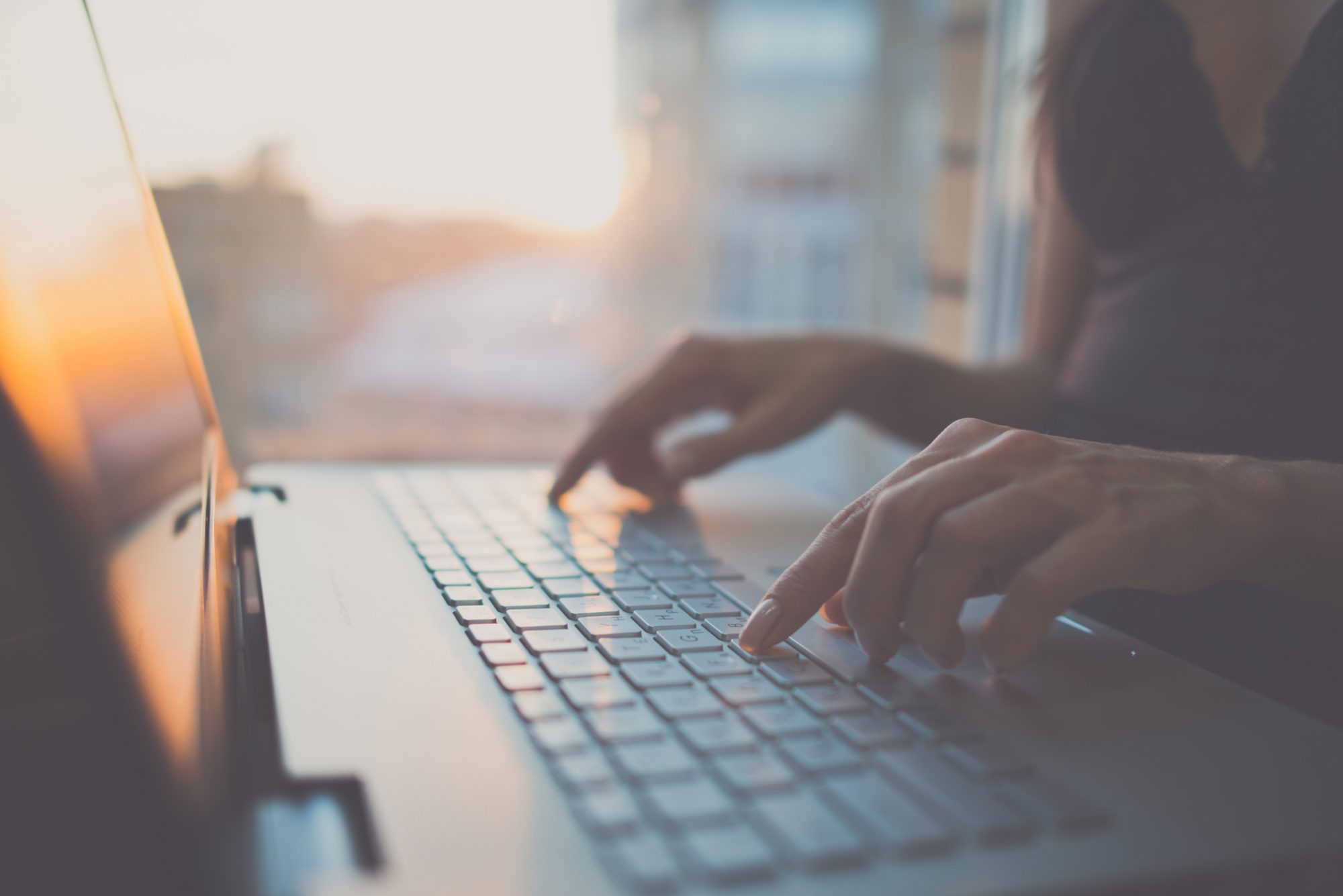 Woman using laptop, searching web, browsing information, having workplace at home