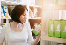 Woman reading product information on label