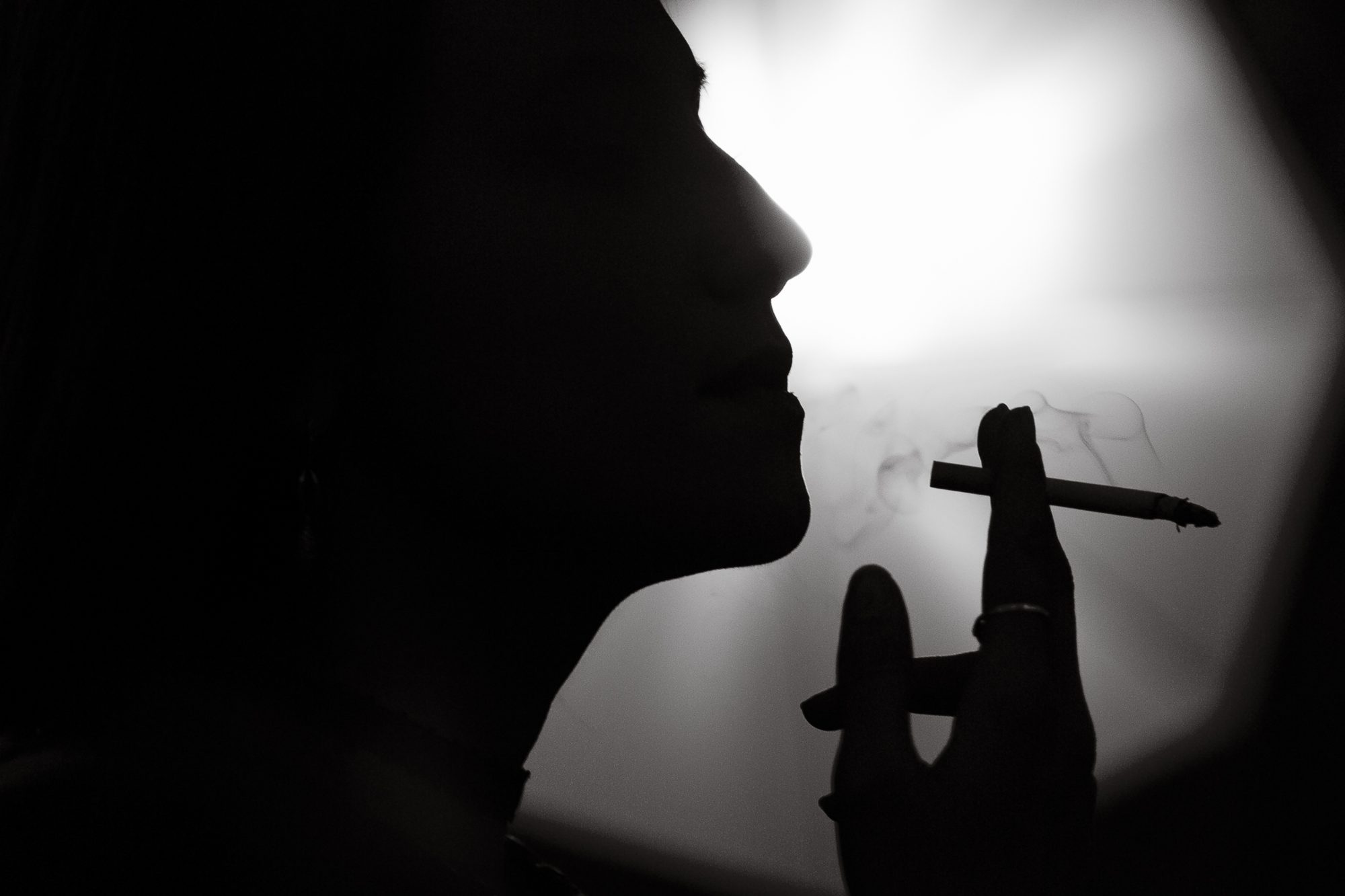 Woman smoking a cigarette outdoors