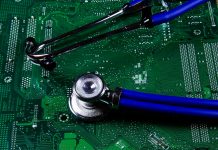 Digital health patient data storage concept - Isolated blue stethoscope on green computer circuit board