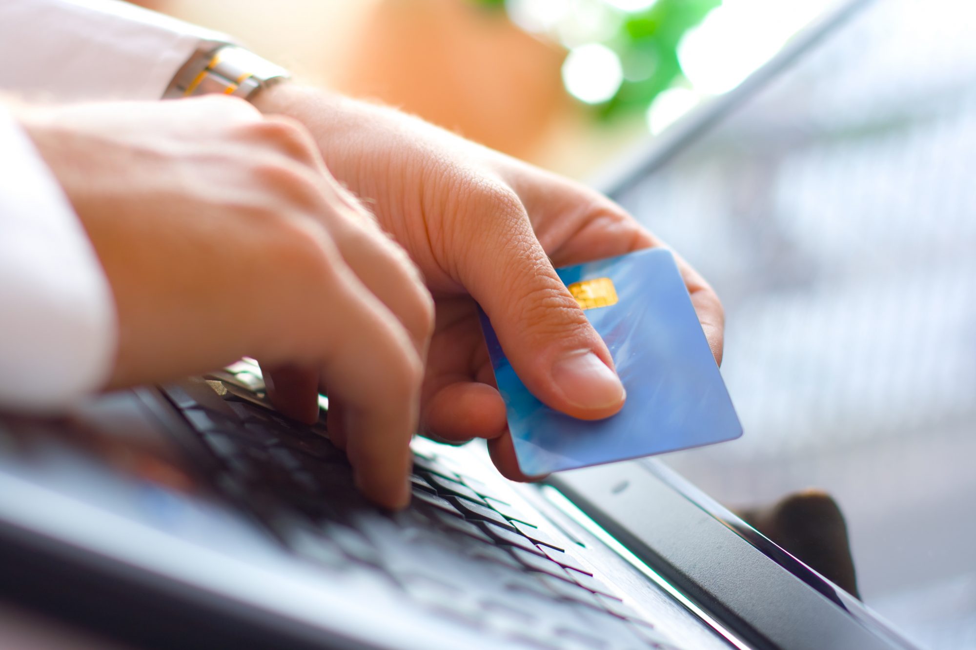 Young man paying with a credit card. Shallow depth of field