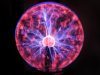 Electrical plasma ball sphere of pink and blue energy spikes, physics education