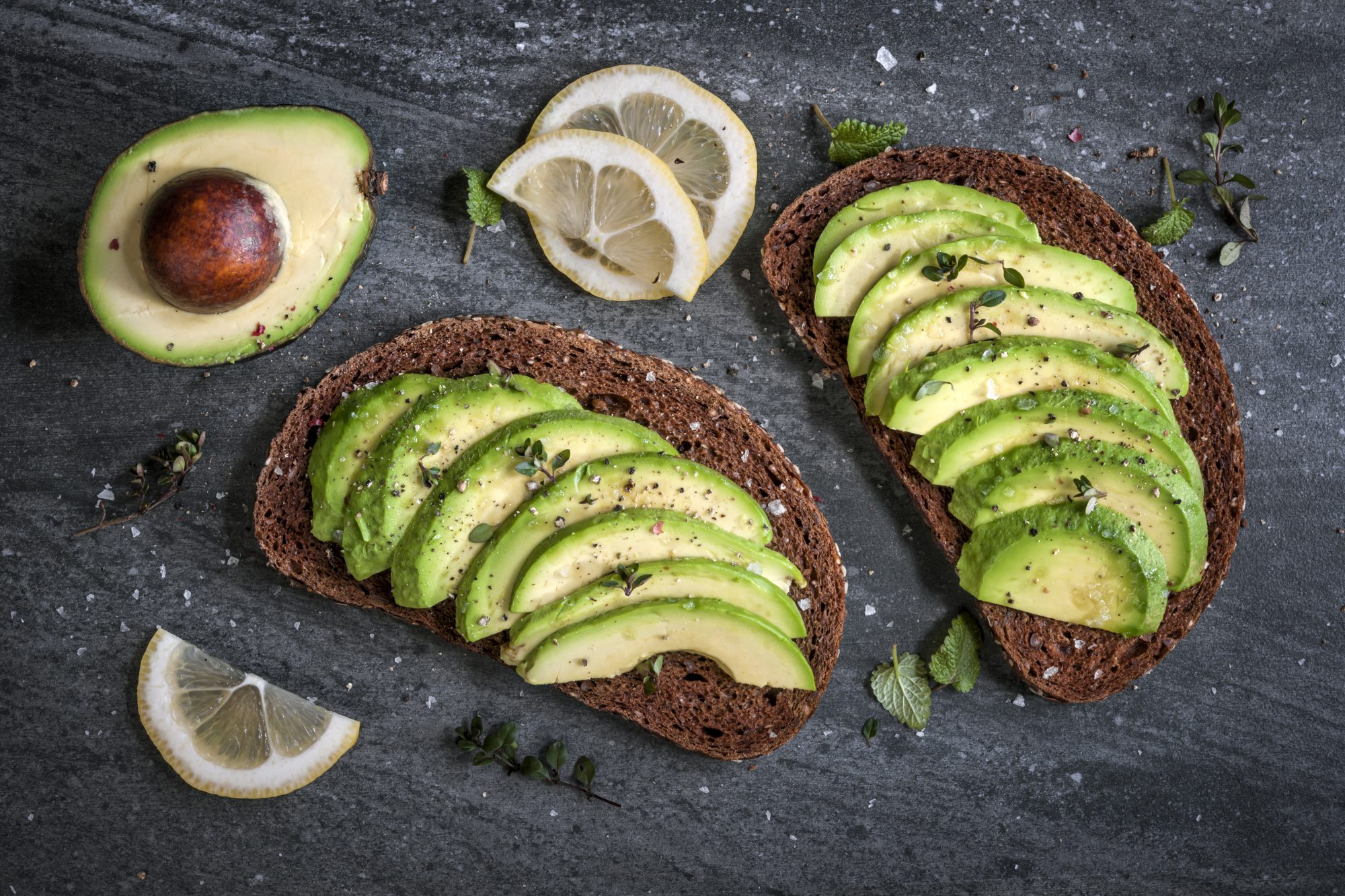 Avocado sandwich on dark rye bread made with fresh sliced avocados from above