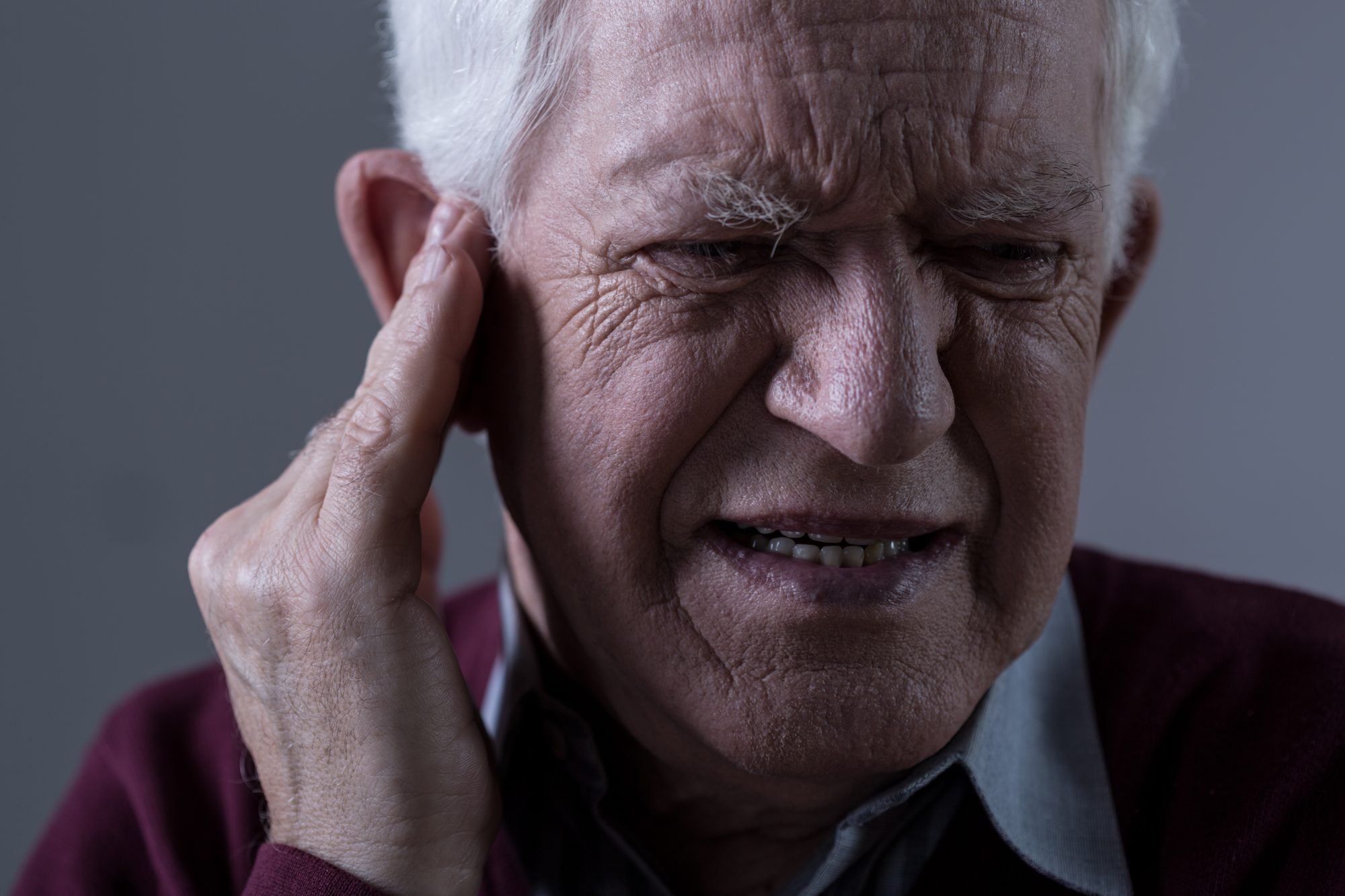 Old man suffering from tinnitus 