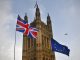 Protesters flags of United Kingdom and European Union outside Parliament in Westminster during the Brexit debates. A British Airways flight passes overhead