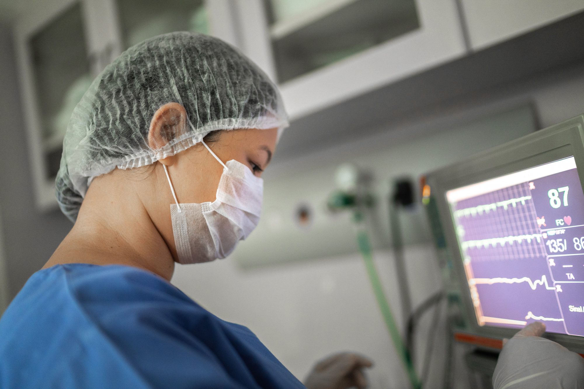 Anesthesiologist watching computer monitor on a surgery in hospital