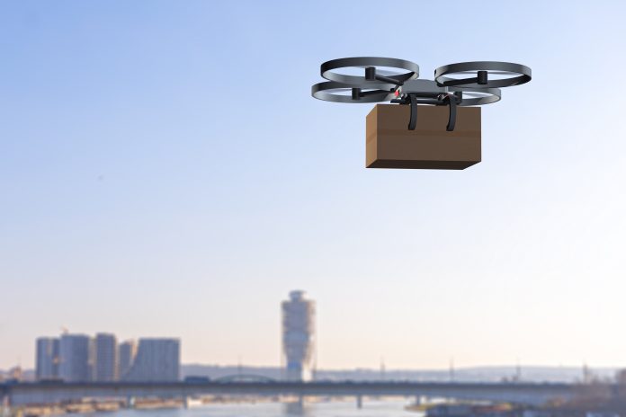 delivery drone flying above the city delivery drone carrying a package flying above the city