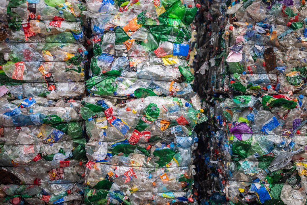 At the recycling center, plastic bottles are collected and packed for recycling