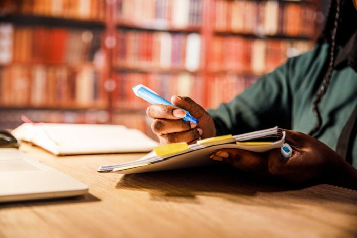 Marking notes with a highlighter, close-up, university education