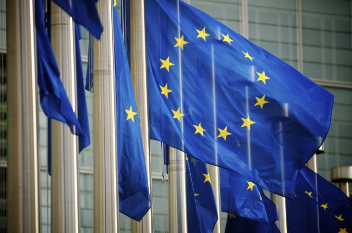 "EU flags fly in a row in front of the European Commission building in Brussels, Belgium"