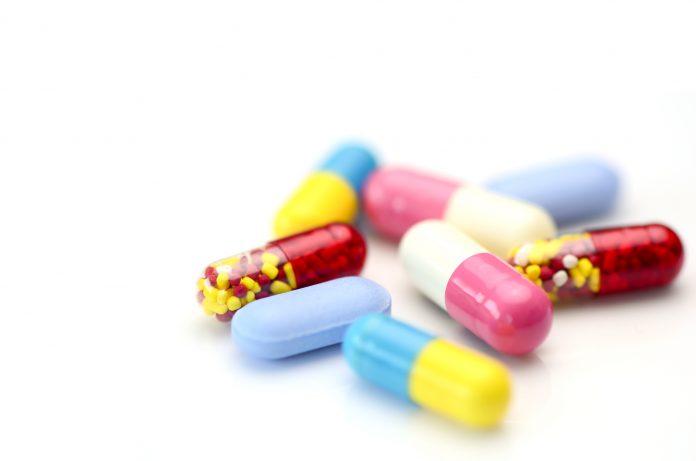 Oral medication background with warm light.Colorful of oral medications on White Background.