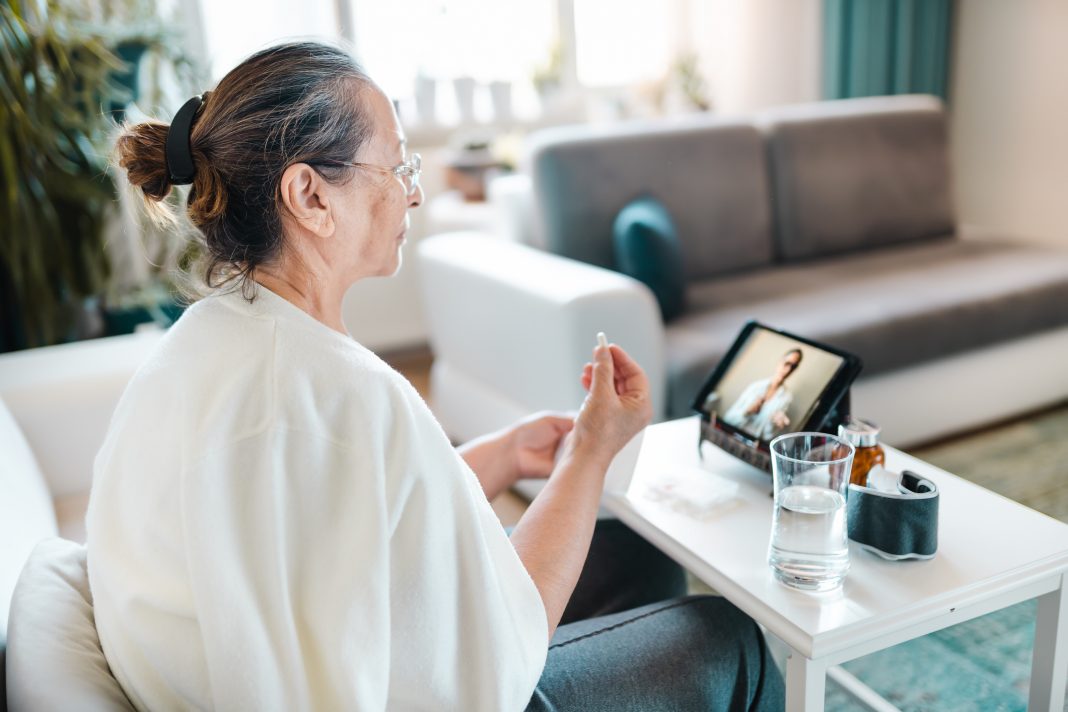 Woman video calling with female healthcare person