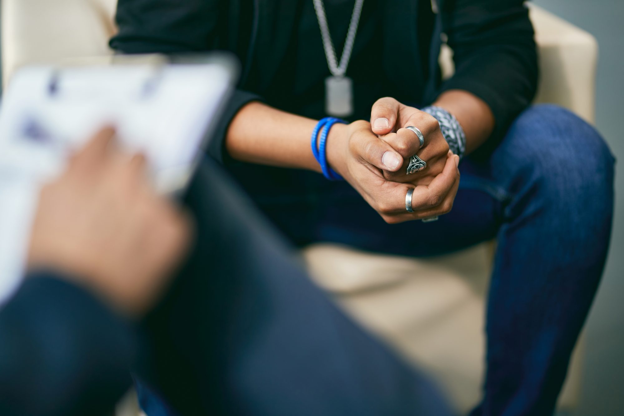 Close-up of African American teenage boy having a session with mental health professional at counselling center.