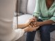 African psychologist hold hands of girl patient, close up. Teenage overcome break up, unrequited love. Abortion decision. Psychological therapy, survive personal crisis, individual counselling concept