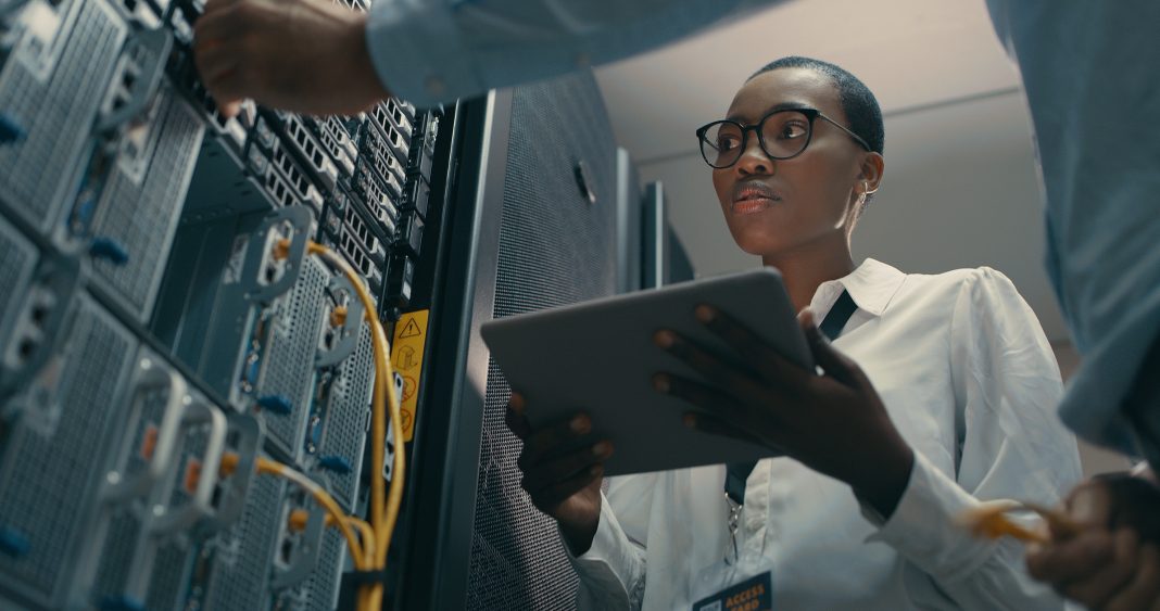 woman using a digital tablet while working in a data centre