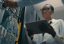 woman using a digital tablet while working in a data centre