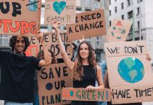 Enthusiastic young people making strike on the street, fighting for saving environment and protesting for climate changes.