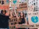 Enthusiastic young people making strike on the street, fighting for saving environment and protesting for climate changes.