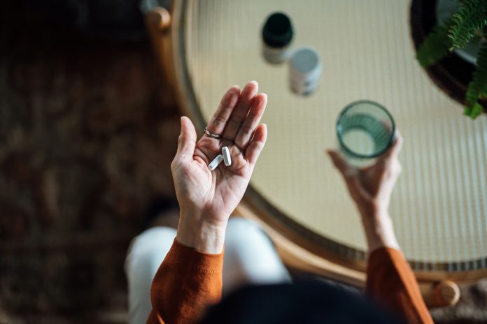 image of older woman taking medicine drugs