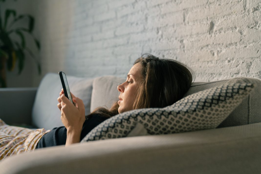 Sad woman using cellphone