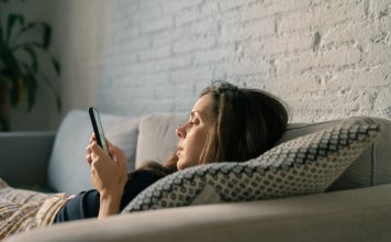 Sad woman using cellphone