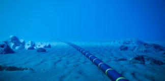 Underwater fiber-optic cable on ocean floor.